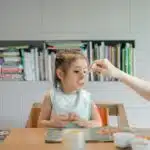 a child eating from a spoon